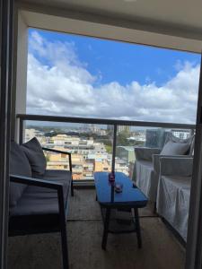 a balcony with a couch and a table and a view at Darling Harbour Luxurious Retreat in Sydney