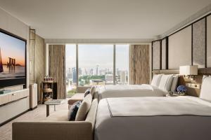a hotel room with two beds and a flat screen tv at Marina Bay Sands in Singapore