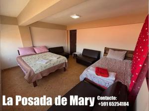 a hotel room with two beds and a couch at La Posada de Mary Departamento 1 in Sucre