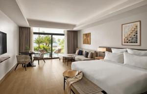 a bedroom with a large bed and a living room at Crowne Plaza Fiji Nadi Bay Resort & Spa by IHG in Nadi