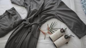 a clock on a bed with two objects on it at Sleepy Gypsea Villa Siargao - Diamond in Catagnan +19 photos