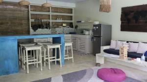 a kitchen with a blue counter and a table and chairs at Sleepy Gypsea Villa Siargao - Diamond in Catagnan