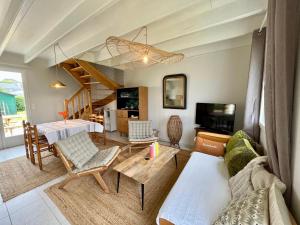 a living room with a couch and a table at Charmante maison proche plage à Groix, 2 chambres - FR-1-813-3 in Groix