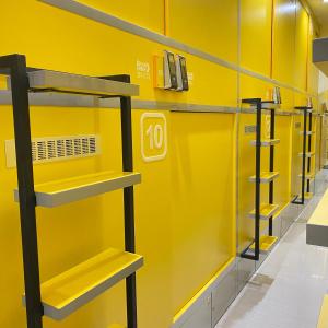 a row of shelves in a store with yellow walls at Rosalyne House Malioboro 2 in Sentool