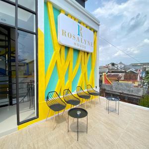 a row of chairs in front of a building at Rosalyne House Malioboro 2 in Sentool +65 photos