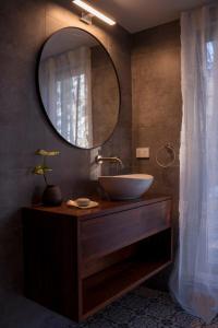a bathroom with a sink and a mirror at Braelee Bower in Rollands Plains