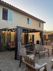 a patio with a gazebo with chairs and a couch at 4Bd Spacious Oasis near wineries in Menifee +52 photos