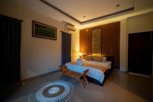 Postel nebo postele na pokoji v ubytování Alit Bungalow Ubud