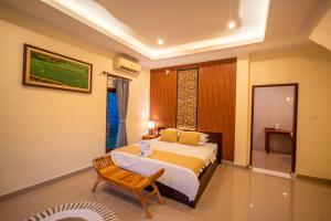 Postel nebo postele na pokoji v ubytování Alit Bungalow Ubud