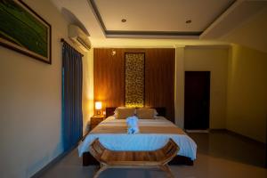 Postel nebo postele na pokoji v ubytování Alit Bungalow Ubud
