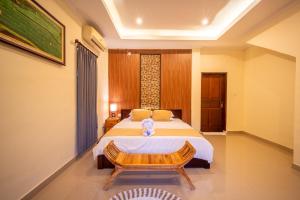 Postel nebo postele na pokoji v ubytování Alit Bungalow Ubud
