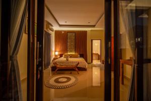 Postel nebo postele na pokoji v ubytování Alit Bungalow Ubud