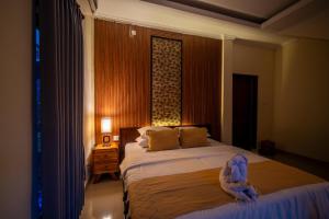 Postel nebo postele na pokoji v ubytování Alit Bungalow Ubud