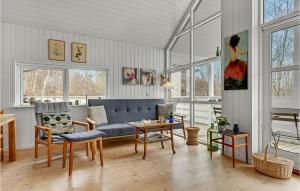 a living room with a blue couch and a table at 3 Bedroom Cozy Home In Grenaa in Grenå