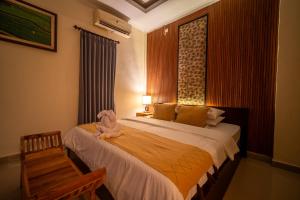 Postel nebo postele na pokoji v ubytování Alit Bungalow Ubud