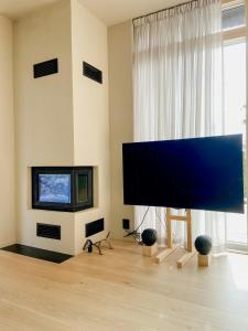 a living room with a large flat screen tv at Paradis Med Pool Nära Naturens Vackra Vyer in Djurhamn +32 photos