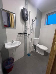 a bathroom with a toilet and a sink at RedHouse Sky Garden Klabang in Ipoh +15 photos