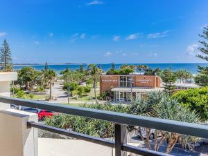 a view of the beach from the balcony of a resort at Luxury Oceanfront Haven with a Private Rooftop Spa in Kingscliff