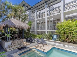 an apartment building with a swimming pool and a resort at Luxury Oceanfront Haven with a Private Rooftop Spa in Kingscliff