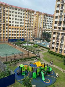 a park with a playground and a tennis court at FEELS LIKE HOMIE STAYCATION in Pasig City in Manila