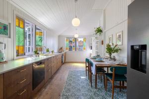 a kitchen with a table and a dining room at SEASIDE HAVEN Luxe Four BR Oasis with Plunge Pool in Brisbane