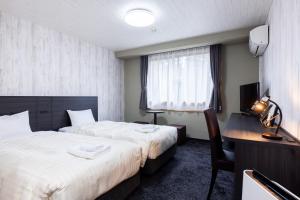 a hotel room with two beds and a desk at Select Inn Fujisan Gotemba in Gotemba +37 photos