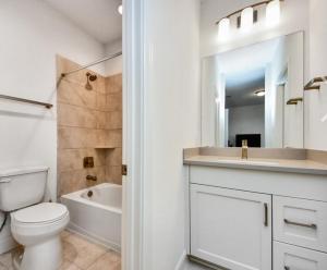 a white bathroom with a toilet and a sink at Prívate Room In Cypress in Hot Wells