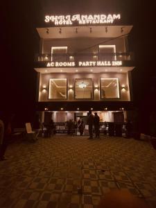 a man standing in front of a theatre at night at SHRI ANANDAM Inn in Isauli