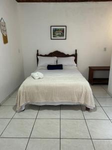 a bedroom with a bed with a black bag on it at La Mar Paraty Hospedaria 04 in Paraty +4 photos