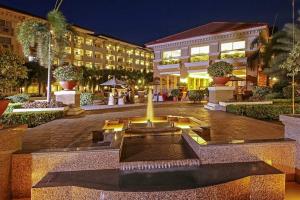 a courtyard with a fountain in front of a building at Your Comfort Zone Staycation1 in Manila