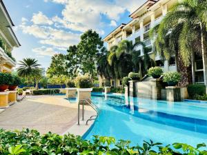 a swimming pool in front of a building at Your Comfort Zone Staycation1 in Manila +22 photos