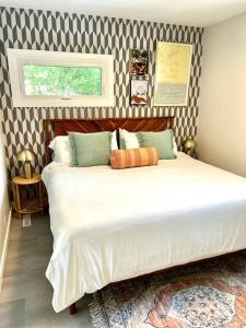 a bedroom with a large white bed in a room at UncleLarry's Lake Place, Sleeps 10 & Hot Tub in LaPorte