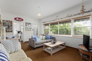 a living room with a couch and a table at Old Meets New in Point Lonsdale