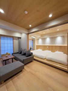 a large bedroom with two beds and a couch at SUN House asakusabashi akihabara tokyo in Tokyo