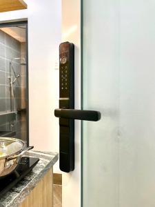a doorhandle to a refrigerator in a kitchen at Serviced Apartment With High View in Can Tho +46 photos
