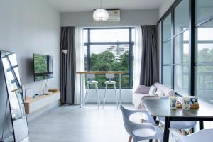 a living room with a couch and a table at Jesselton Quay by SNUG SPACE in Kota Kinabalu