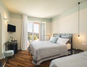 Postel nebo postele na pokoji v ubytování Camere Relais Filomare