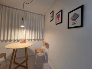 a table and chairs in a room with a window at Dodam Stay in Seoul