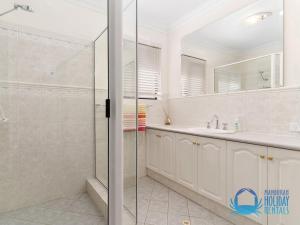 a bathroom with a shower and a sink at Canal Elegance In Yunderup in Mandurah +26 photos