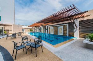 a house with a swimming pool and some chairs at NU Hotel in Bintulu