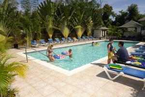 a group of people sitting in a swimming pool at Legends Beach Resort in Negril