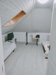 an attic room with two beds and a desk at Casa Maria in Sarmizegetusa