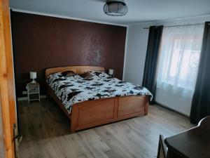 a bedroom with a bed with a dog laying on it at Casa Maria in Sarmizegetusa