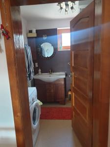 a bathroom with a sink and a toilet and a mirror at Casa Maria in Sarmizegetusa +19 photos