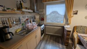a small kitchen with a sink and a window at Ferienwohnung mit Terrasse für 1-4 Personen in Altena