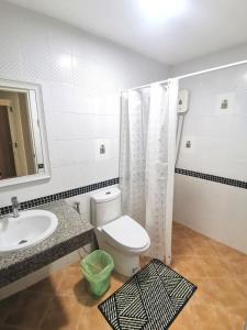 a bathroom with a toilet and a sink and a mirror at Kata beach Townhouse BL2 in Kata Beach