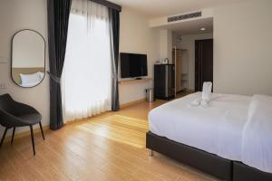 Un dormitorio con una cama, una silla y un espejo. en Daoneua Riverside Resort, en Muang Fuang