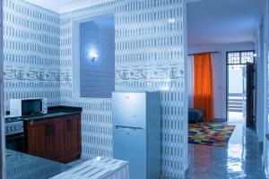 a kitchen with a refrigerator and a microwave at Entire home in Mlole, Kigoma, Tanzania in Kigoma