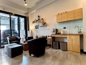 a living room with two chairs and a kitchen at P and B's Home in San-k'un-shen