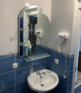 a bathroom with a sink and a mirror at Гостевой дом "Светлана" in Cholpon-Ata +78 photos
